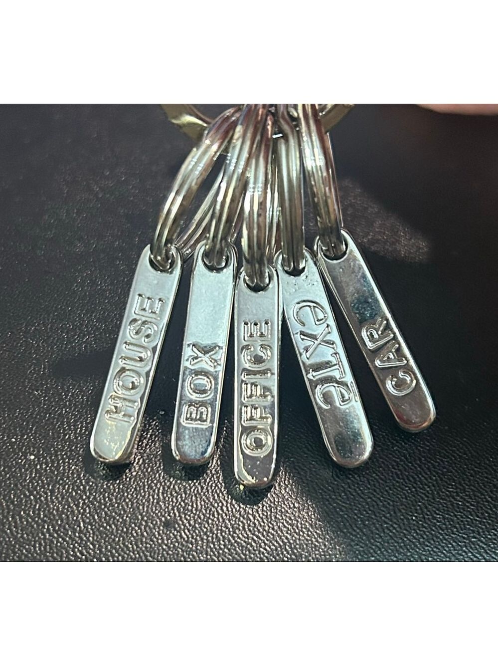 Exte brand silver tone key ring with 5 labeled removable rings